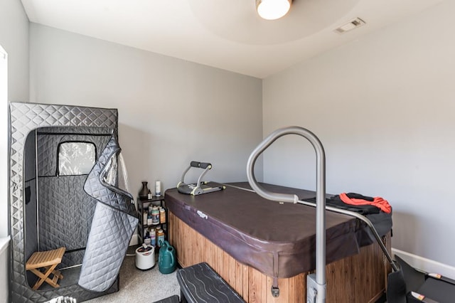 carpeted bedroom featuring visible vents