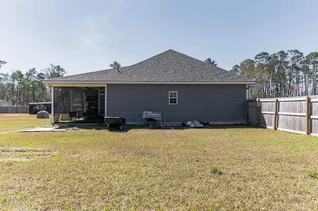 back of property featuring a patio area, a yard, a fenced backyard, and a shingled roof