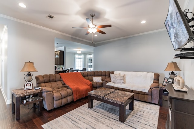 living room featuring visible vents, wood finished floors, and ornamental molding