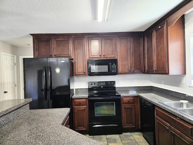 kitchen with sink, black appliances, and a textured ceiling