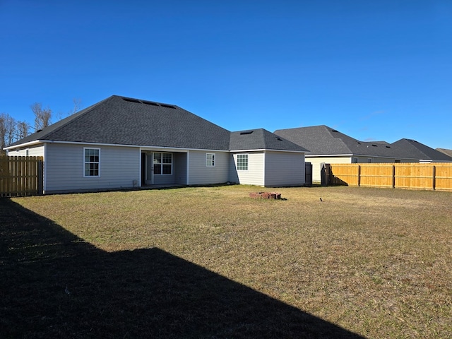 back of house with a lawn