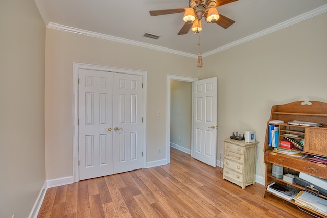 bedroom with crown molding, baseboards, visible vents, and light wood-type flooring