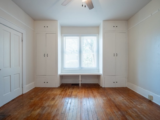 interior space with a ceiling fan and wood finished floors