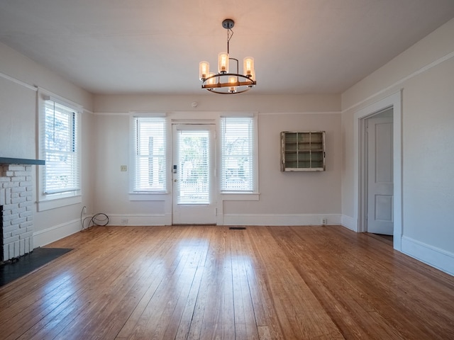 doorway to outside with wood finished floors and baseboards