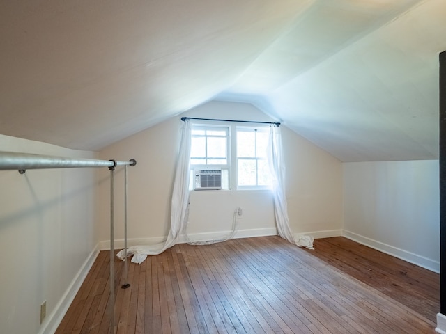 bonus room with baseboards, vaulted ceiling, and wood finished floors