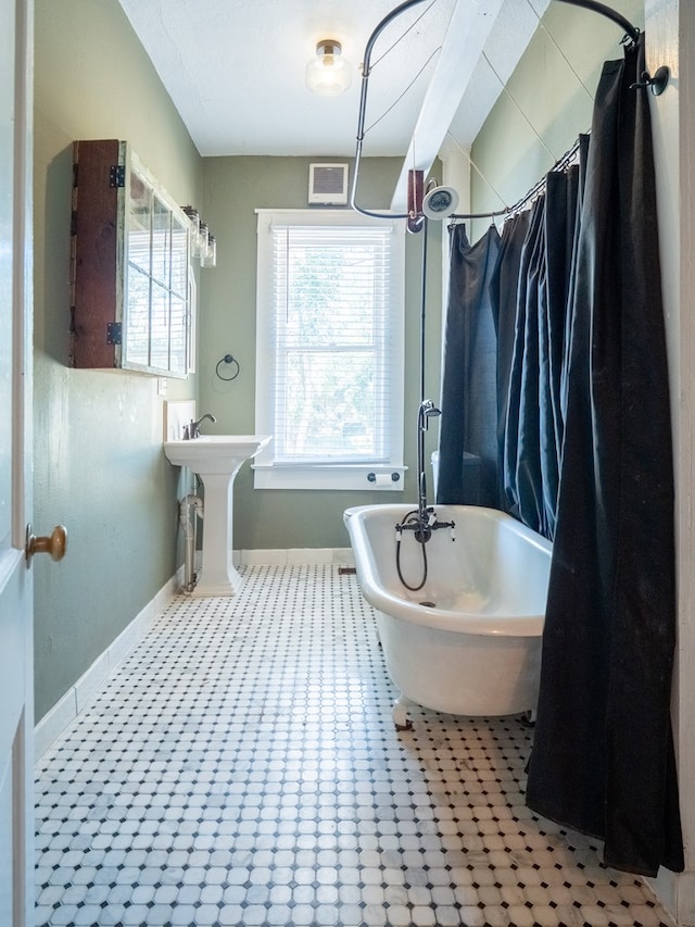 full bath with shower / bath combo, visible vents, and baseboards