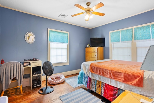 711 S Parrish Ave, Adel, GA 31620 - bedroom featuring visible vents, crown molding, hardwood / wood-style floors, baseboards, and a ceiling fan