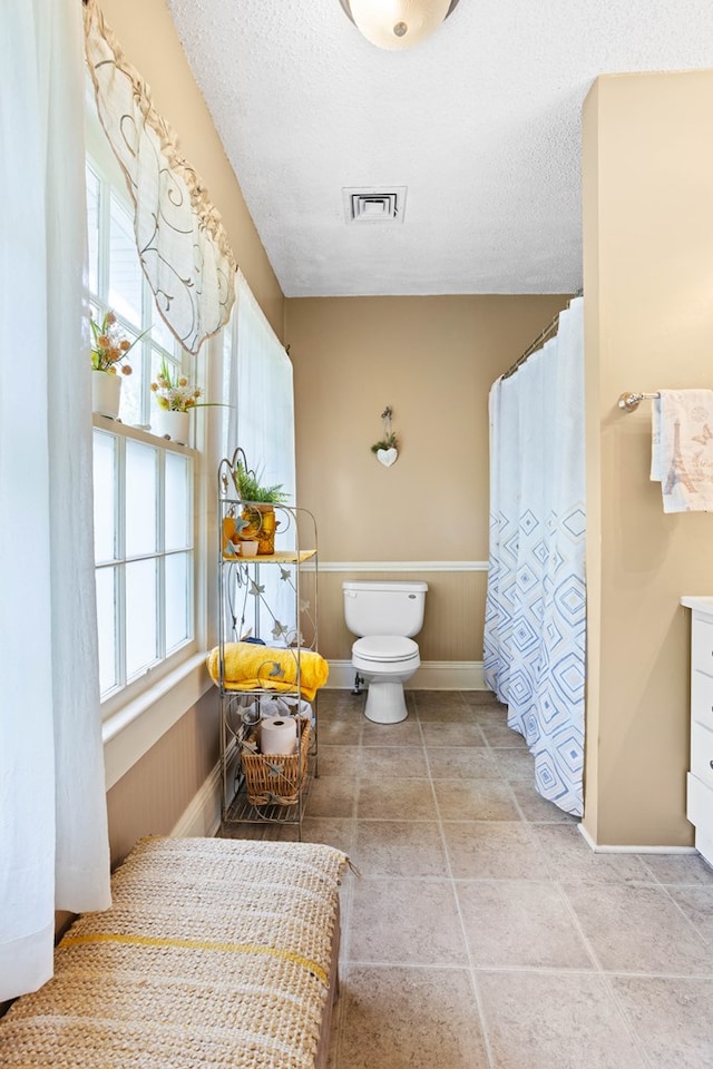 711 S Parrish Ave, Adel, GA 31620 - full bathroom with baseboards, visible vents, toilet, and a wealth of natural light