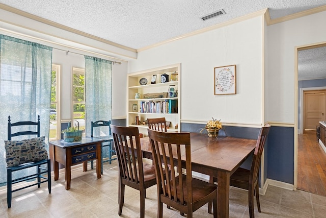 711 S Parrish Ave, Adel, GA 31620 - dining space with light tile patterned flooring, a textured ceiling, visible vents, and ornamental molding