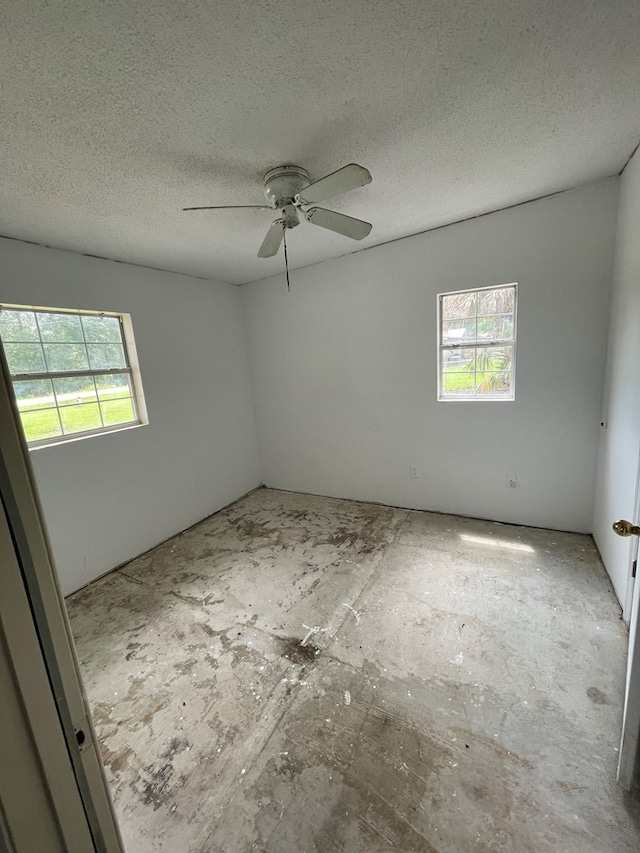 spare room featuring a textured ceiling and ceiling fan