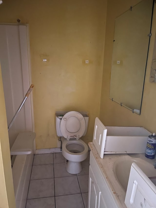 bathroom featuring tile patterned floors, toilet, vanity, and baseboards