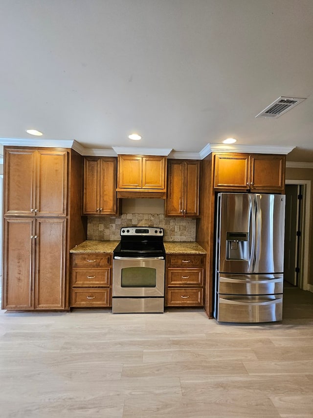 kitchen featuring light stone countertops, stainless steel appliances, backsplash, crown molding, and light wood-type flooring