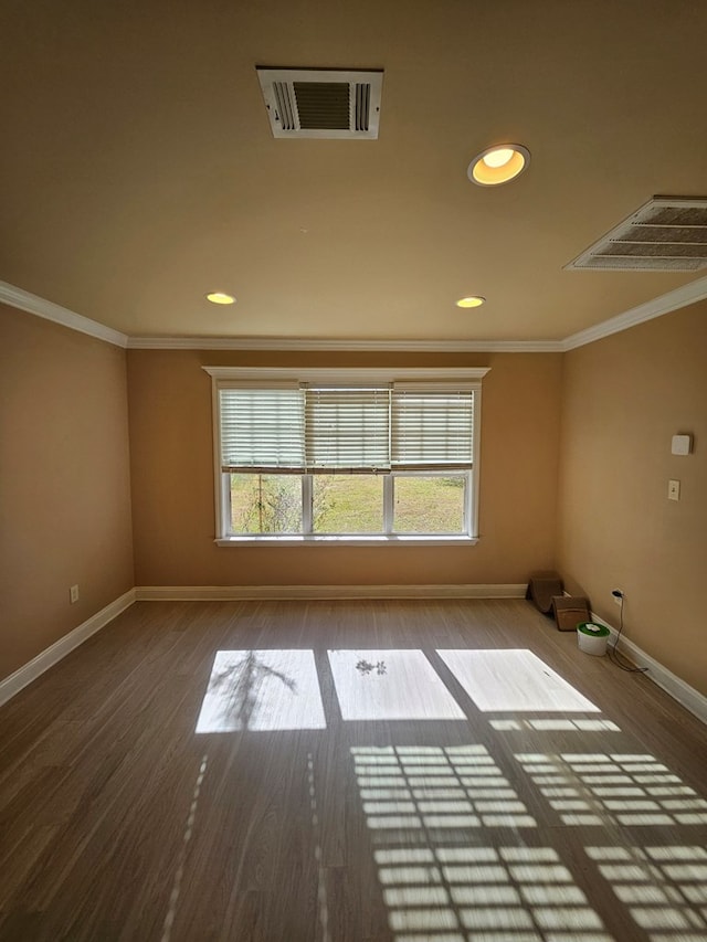 empty room with wood-type flooring and ornamental molding