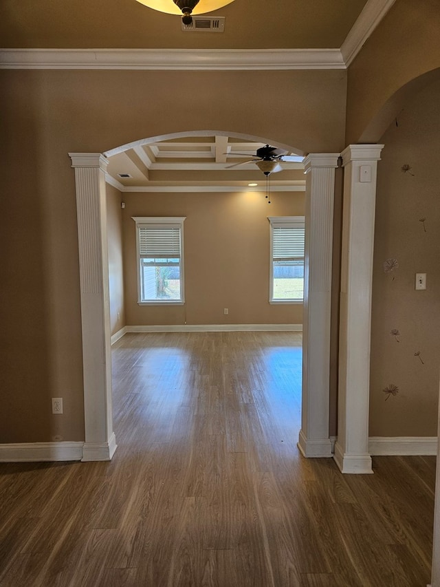 spare room with ornate columns, a wealth of natural light, and ornamental molding