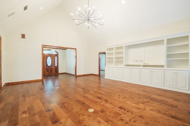 4849 Oak Arbor Dr, Valdosta, GA 31602 - unfurnished living room featuring high vaulted ceiling, a chandelier, and light wood finished floors