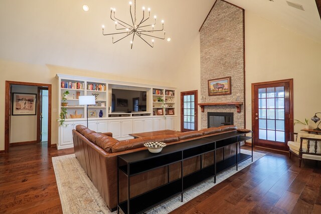 4849 Oak Arbor Dr, Valdosta, GA 31602 - living room with a chandelier, high vaulted ceiling, plenty of natural light, dark wood finished floors, and a brick fireplace