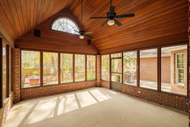 unfurnished sunroom with lofted ceiling, wooden ceiling, and ceiling fan