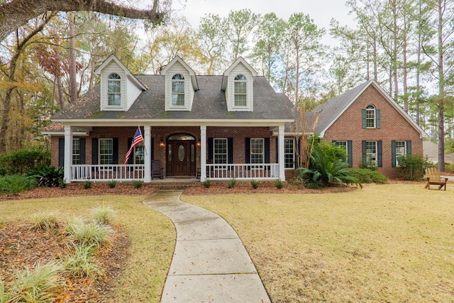 cape cod home with a porch and a front yard