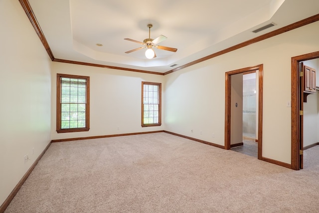 4849 Oak Arbor Dr, Valdosta, GA 31602 - spare room with a raised ceiling, carpet floors, ceiling fan, and ornamental molding