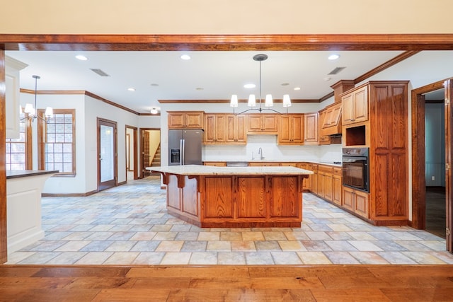 4849 Oak Arbor Dr, Valdosta, GA 31602 - kitchen featuring stainless steel fridge with ice dispenser, oven, ornamental molding, a center island, and a breakfast bar