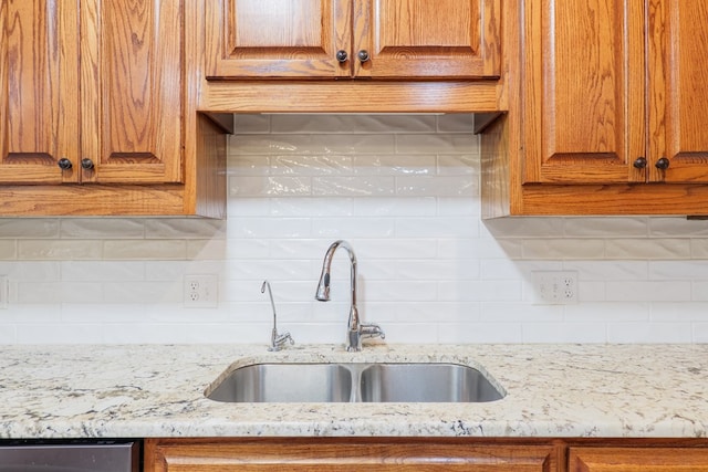 4849 Oak Arbor Dr, Valdosta, GA 31602 - kitchen featuring decorative backsplash, brown cabinets, and light stone countertops