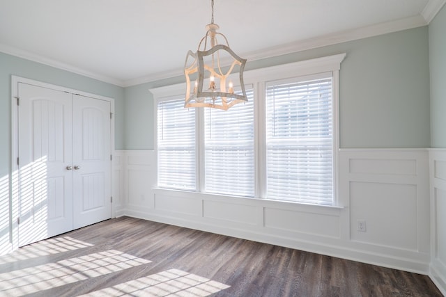 unfurnished dining area featuring dark hardwood / wood-style flooring, crown molding, and a wealth of natural light