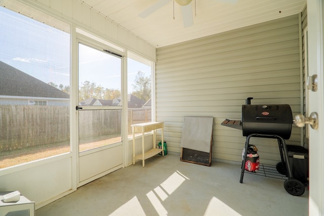 sunroom / solarium featuring ceiling fan