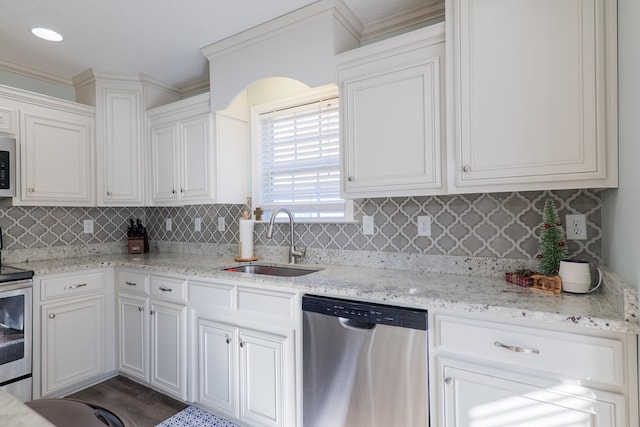 kitchen featuring sink, white cabinetry, stainless steel appliances, and tasteful backsplash