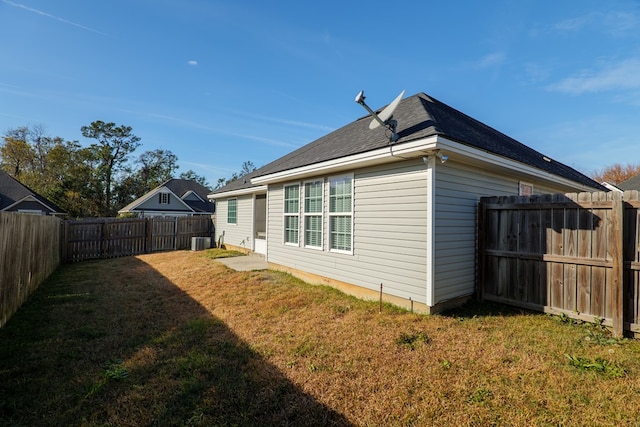 view of property exterior featuring cooling unit and a lawn