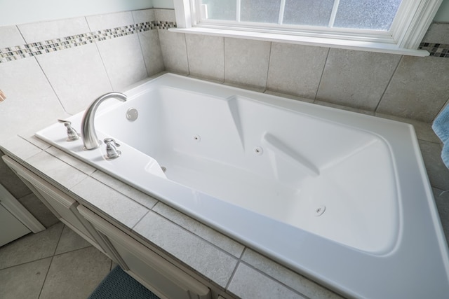 bathroom with tile patterned flooring and a washtub