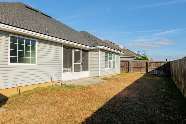 rear view of property with a lawn