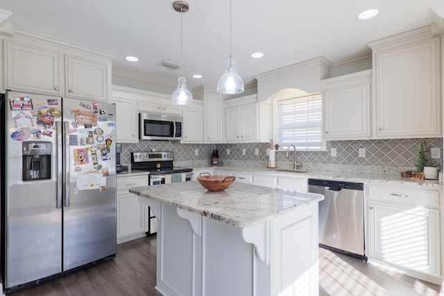 kitchen with white cabinetry, a center island, sink, hanging light fixtures, and stainless steel appliances