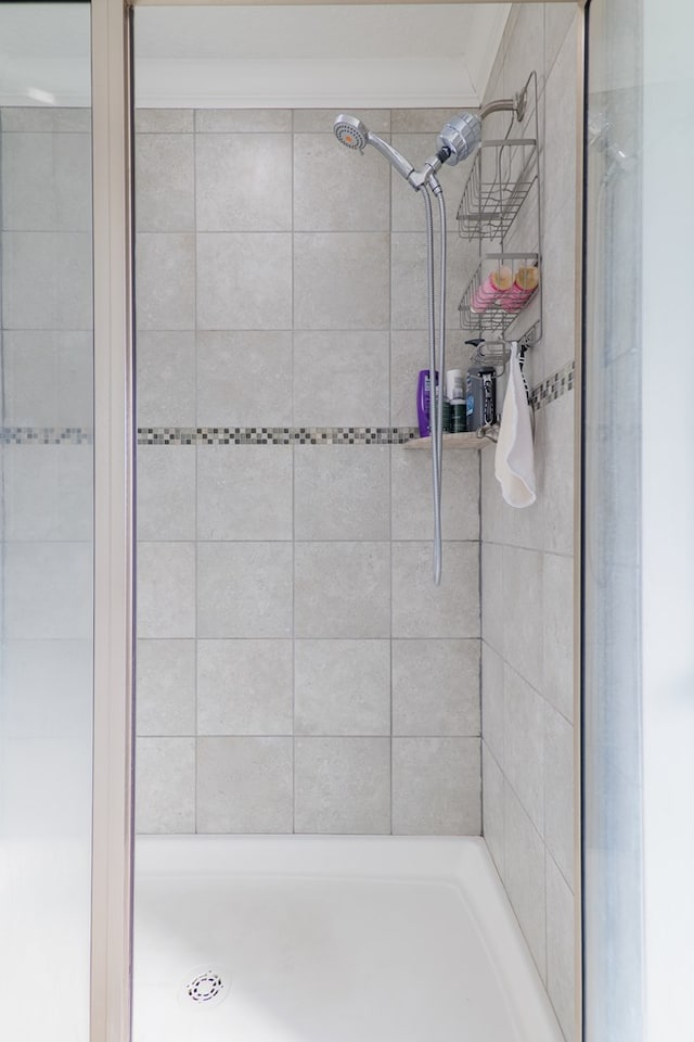 bathroom with tiled shower