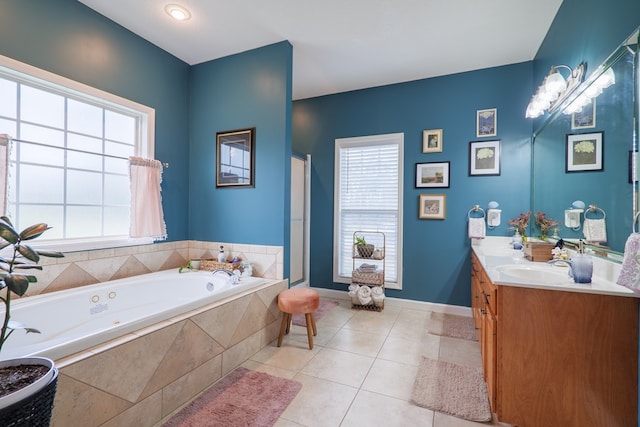 bathroom featuring tile patterned floors, tiled tub, and vanity