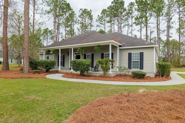 ranch-style house with covered porch and a front yard