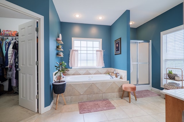 bathroom featuring tile patterned floors and separate shower and tub