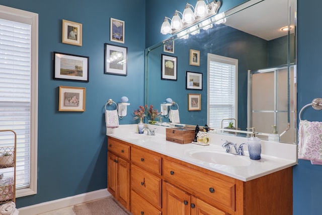 bathroom with tile patterned flooring, vanity, and a shower with shower door