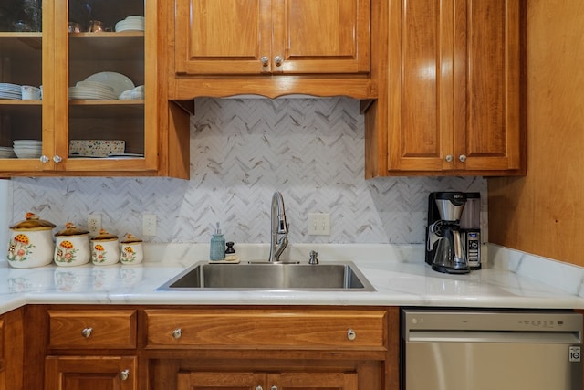 kitchen with tasteful backsplash, sink, and stainless steel dishwasher