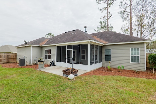 rear view of house featuring a yard, a patio, cooling unit, and a sunroom