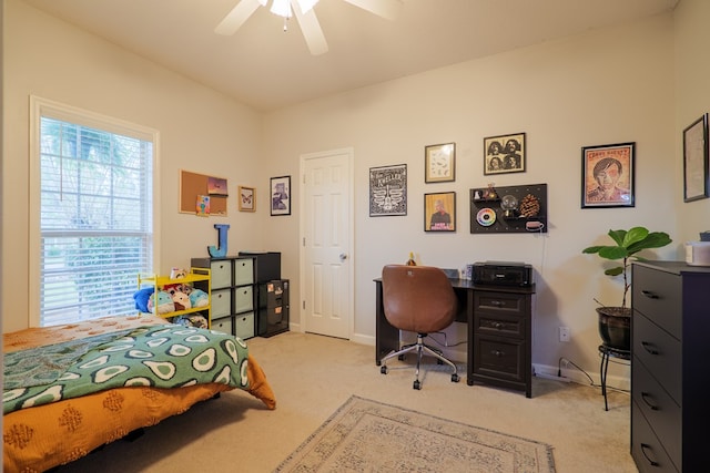 bedroom featuring ceiling fan and light carpet