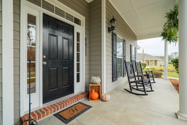 view of exterior entry with a porch