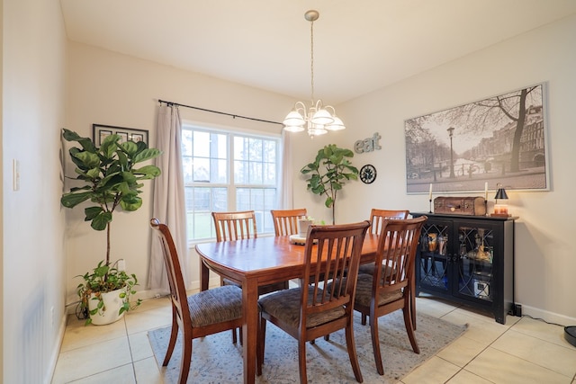 dining area with light tile patterned floors and a notable chandelier