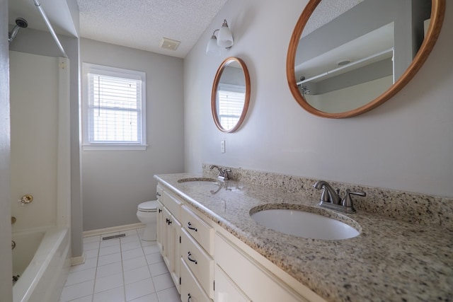 bathroom featuring toilet, a textured ceiling, a sink, and visible vents