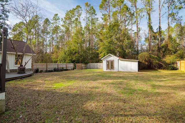 view of yard with a fenced backyard, a shed, and an outdoor structure