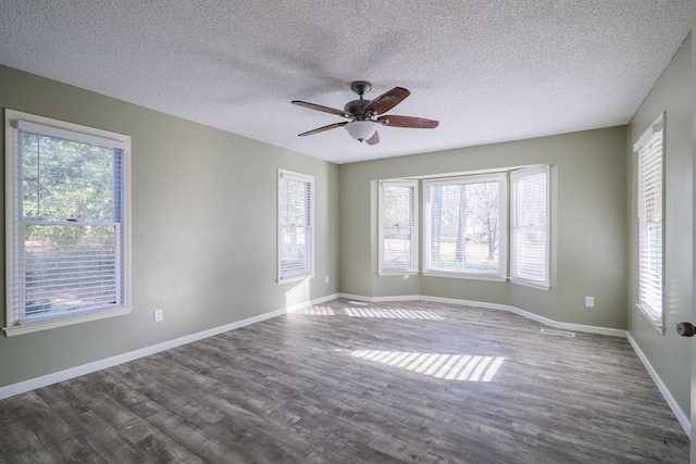 unfurnished room featuring a ceiling fan, a textured ceiling, baseboards, and wood finished floors