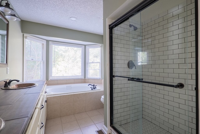 full bathroom featuring a stall shower, vanity, toilet, and tile patterned floors