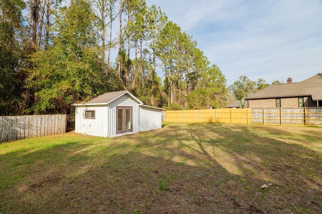 view of yard featuring an outdoor structure and a fenced backyard