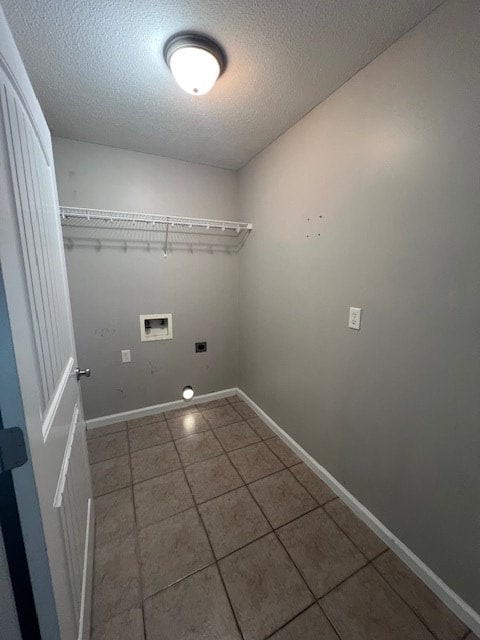 3664 Druid Oaks Dr, Valdosta, GA 31602 - clothes washing area featuring baseboards, washer hookup, laundry area, hookup for an electric dryer, and a textured ceiling