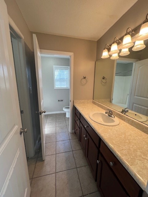3664 Druid Oaks Dr, Valdosta, GA 31602 - full bath with baseboards, toilet, vanity, and tile patterned flooring