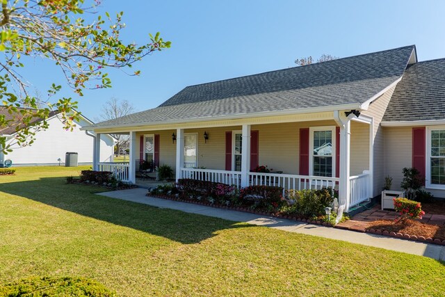 view of front of home with a porch, a front lawn, and roof with shingles